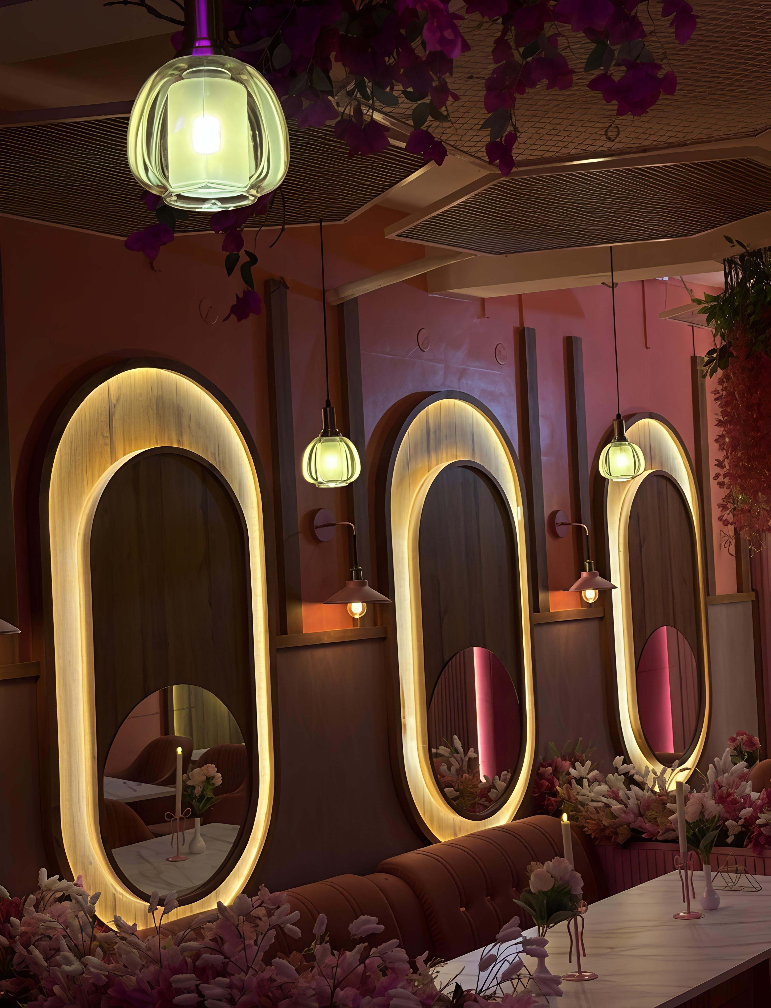 Rose-toned booth corner with soft lamps